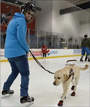  ?? Photo by: Essdras M. Suarez / The Washington Post ?? Emily Molchan skates with guide dog Remington at a skating session in January.