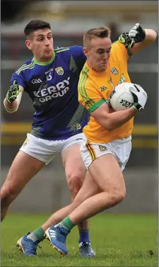  ??  ?? Ronan Ryan tries to break away from Kerry’s Paul Geaney.