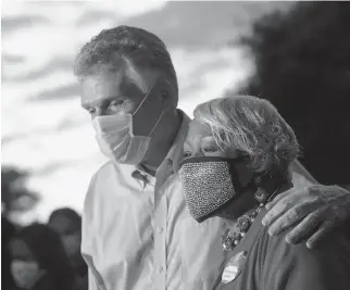  ?? KAITLIN MCKEOWN/STAFF FILE ?? Former Virginia Gov. Terry McAuliffe embraces state Sen. Louise Lucas after a rally demanding justice for the 19 people charged following the June Confederat­e monument protest in Portsmouth.