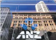  ??  ?? The logo of ANZ Banking Group is displayed in the window of a new branch in Sydney in 2016. The bank and two others have been hit with criminal cartel charges in Australia.