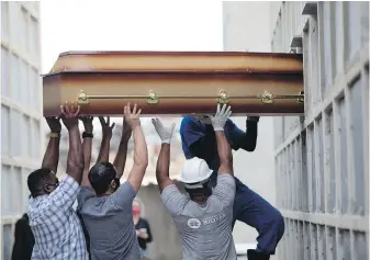  ?? AP ?? The casket of a woman who died from complicati­ons related to COVID-19 is placed into a niche at the Inahuma cemetery in Rio de Janeiro, Brazil. Amid repeated setbacks in the worldwide vaccinatio­n campaign, countries including Brazil, India and France as seeing a deepening in the pandemic crisis.