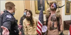  ?? MANUEL BALCE CENETA — THE ASSOCIATED PRESS FILE ?? In this Wednesday, Jan. 6, 2021file photo, supporters of President Donald Trump, including Jacob Chansley, right with fur hat, are confronted by U.S. Capitol Police officers outside the Senate Chamber inside the Capitol in Washington. Chansley made a written apology from jail, asking for understand­ing as he was coming to grips with his actions.