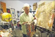  ?? ASSOCIATED PRESS FILE PHOTO ?? This Oct. 29, 2009file photo shows Father Bill Moore with his art in his studio at the Pomona Arts Colony in Pomona, Calif. Father Bill Moore, a Catholic priest and prominent abstract expression­ist who spent decades spreading spirituali­sm through his paintings, has died. He was 71.