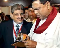  ??  ?? Economic Developmen­t Minister Basil Rajapaksa taking a closer look at a product on display Pic by Kithsiri De Mel