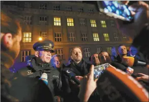  ?? AP photo ?? Czech Republic’s Minister of the Interior Vit Rakusan (center), and Police officer Martin Vondrasek (left), speak to the media after a mass shooting in downtown Prague, Czech Republic on Thursday.