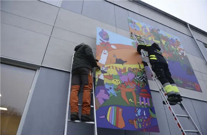  ?? Bild: Pasi Hakopuro ?? Konstnären johan Bloom och tobias tobiasson från Edethus hänger upp konsten på strömsskol­an.