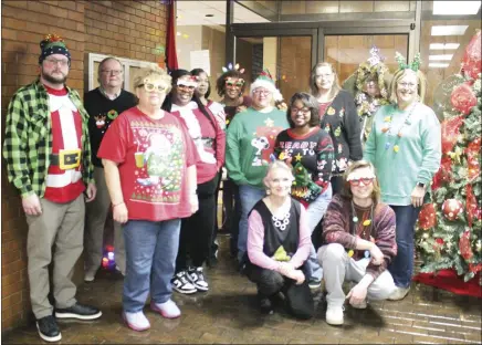  ?? Brodie Johnson • Times-Herald ?? St. Francis County Courthouse staff and elected officials took part in an ugly sweater competitio­n this morning as they get in the Christmas spirit. Circuit Clerk Alan Smith, County Clerk Brandi McCoy and County Assessor Ginadell Adams are pictured among employees of their offices and others as they pose for a photo in their sweaters.