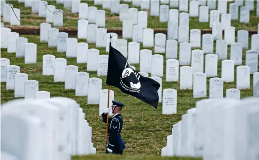  ??  ?? LEFT BEHIND? A POW-MIA flag at Arlington National Cemetery in Virginia. Few issues in America have been more painful than the fate of those who went missing during the Vietnam War.