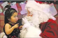  ?? AP PHOTO ?? This Dec. 5, 2017, photo shows Caasi Lockwood sits on Santa’s lap in Saint Michael, Alaska, a remote island community off the state’s western coast in the Bering Strait.