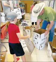  ?? (Courtesy Photo) ?? Members of Prairie Grove United Methodist Church assemble boxes for food. The church has been providing food during the covid-19 pandemic since March.