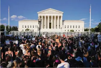  ?? Jacquelyn Martin/Associated Press ?? Protesters fill the street outside the Supreme Court after the court’s decision to overturn Roe v. Wade in June. If Congress were to pass an abortion rights law, the court could strike it down.