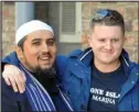  ??  ?? Hug: Mr Robinson with Muslim leader Mohammed Ansar