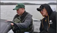  ?? (Arkansas Democrat-Gazette/Bryan Hendricks) ?? Bill Eldridge and Ed Kubler (right) look at the image of newly placed fish attractors on Eldridge’s electronic graph.