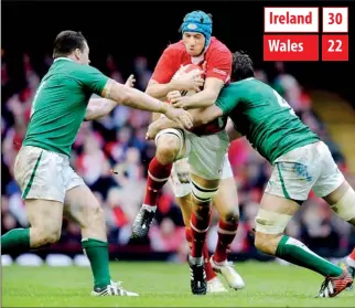  ??  ?? Wales' Scott Williams is tackled by Ireland's Mike McCarthy during their RBS Six Nations rugby match at the Millennium Stadium in Cardiff, February 2, 2013. REUTERS