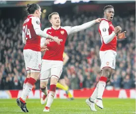  ??  ?? Arsenal’s Danny Welbeck, right, celebrates after scoring against AC Milan.