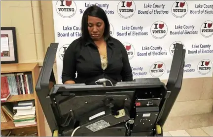  ?? ANDREW CASS — THE NEWS-HERALD ?? Tamela Cameron of Wickliffe votes in the Lake County Elections Board Office at 105 Main St. in Painesvill­e on April 20.