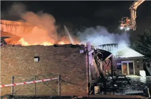  ??  ?? ●●Firefighte­rs at the scene at Huws Gray builders merchants