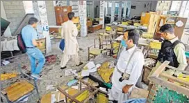  ?? AP ?? Security officials inspect the bombing site in Mardan on Friday.