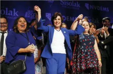  ?? JOHN LOCHER — THE ASSOCIATED PRESS ?? Rep. Jacky Rosen, D-Nev., center, celebrates at a Democratic election night party after winning a Senate seat Wednesday in Las Vegas. A female political movement driven by backlash to President Donald Trump kicked off 2018 by hosting a women’s march in Nevada and 11 months later, that activism helped women win key races across the state, including ousting an incumbent U.S. Senator, electing a female-majority federal delegation and a female-majority state Assembly.