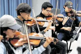  ??  ?? Violinists Abby Elorza, from left, Alexys Gonzalez, Ricardo Jimenez and Zuriel Longoria rehearse. Mariachi Pumas includes an advanced competitiv­e group and a noncompeti­tive group for beginners.