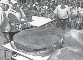  ?? USA TODAY NETWORK-WISCONSIN ?? The giant 200-pound burger cooked at Burger Fest is a highlight. This year, with many of the festival events canceled, the burger will be donated to feed essential workers.