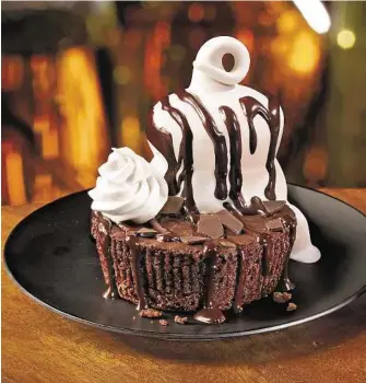  ??  ?? Dairy Queen Dairy Queen’s Stuffed Triple Chocolate Brownie comes with a generous serving of vanilla ice cream.