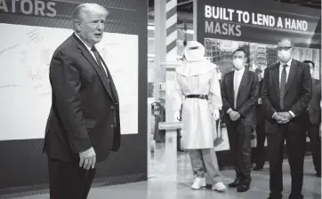  ?? DOUG MILLS The New York Times ?? President Donald Trump tours Ford’s Rawsonvill­e Components Plant in Ypsilanti, Michigan, on Thursday, which has switched to make personal protective equipment to help healthcare workers in the fight against the spread of coronaviru­s.