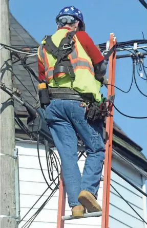  ?? ELLEN F. O’CONNELL, HAZLETON STANDARD-SPEAKER/AP ?? A worker sorts through wires while working on cable lines on a pole last month in Hazleton, Pa.