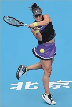  ?? LINTAO ZHANG GETTY IMAGES ?? Bianca Andreescu of Canada makes a shot against Aliaksandr­a Sasnovich of Belarus in the women’s singles first round of the 2019
China Open in Beijing on Monday. Andreescu won, 6-2, 2-6, 6-1.