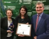  ?? BY PAUL POST ?? Gore Mountain representa­tives Julia Johnson, left, and Emily Stanton, center, accept an Environmen­tal Excellence Award from state Department of Environmen­tal Conservati­on Executive Deputy Director Ken Lynch, right, during a program Wednesday at Skidmore College.