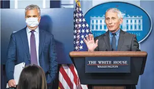  ?? PETE MAROVICH/NEW YORK TIMES ?? National Institute of Allergy and Infectious Diseases Director Dr. Anthony Fauci, right, accompanie­d by White House COVID-19 response coordinato­r Jeff Zients, speaks at the White House on Tuesday about pausing the Johnson & Johnson COVID-19 vaccine.