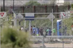  ??  ?? Detainees are seen inside a facility, where tent shelters are being used to house separated family members at the port of entry on Thursday in Fabens, Texas. AP PHOTO/MATT YORK