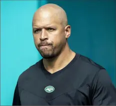  ?? AP file photo ?? New York Jets receivers coach Miles Austin walks onto the field before a game against the Dolphins, Dec. 19, 2021, in Miami Gardens, Fla. Austin has been suspended by the NFL for violating the league’s gambling policy.