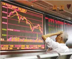  ?? Reuters ?? An investor at a brokerage in Beijing. Securities giant Nomura said it expects China’s economy and exports to weaken and has trimmed forecasts for key China share indices.