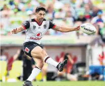  ?? PHOTO: GETTY IMAGES ?? Man of the moment . . . Warriors halfback Shaun Johnson kicks a second field goal with time almost up to beat the Canberra Raiders in Canberra on Saturday.