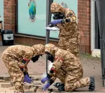  ?? GETTY IMAGES ?? Members of the military work in the Maltings shopping area, close to the bench where Sergei Skripal and his daughter Yulia were found critically ill.