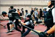  ??  ?? Police detain a young man after fights broke out between pro-china supporters and anti-government protesters at Amoy Plaza in the Kowloon Bay district in Hong Kong, Saturday