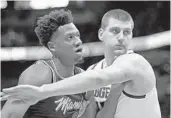  ?? JOHN MCCALL/SUN SENTINEL ?? Heat center Hassan Whiteside (left) works Tuesday night against Nuggets center Nikola Jokic.