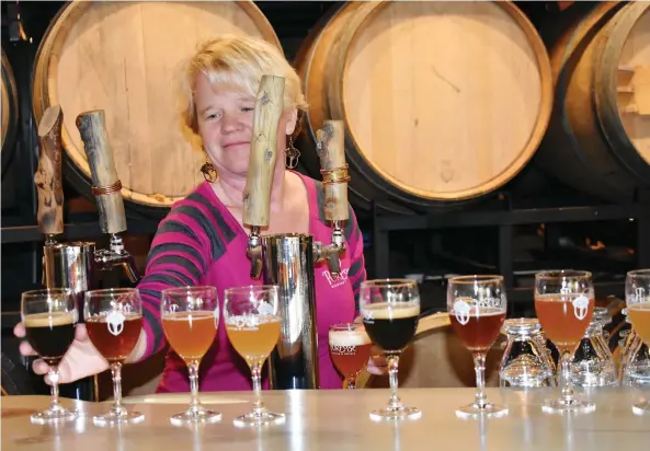  ?? PHOTOS: BARBARa TAYLOR ?? Frezi Bouckaert pours a variety of craft beers for visitors to sample at Purpose Brewing and Cellars in Fort Collins, the craft beer capital of Colorado.