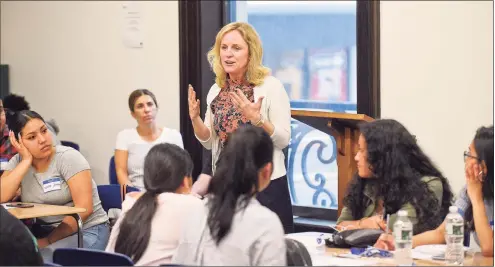  ?? Matthew Brown / Hearst Connecticu­t Media ?? Bridget Fox, president of Stamford Cradle to Career, addresses recent high school graduates at a Kickoff event for a new “Bridge to College” program at Stamford’s Old Town Hall on June 20, 2019. Stamford Cradle to Career organized the event, which is working to address the gap between the percent of Stamford Public School graduates, who say they’re going to attend college (about 90%) and the percent of students (about 70%) who actually go on to start college in the fall of 2019.