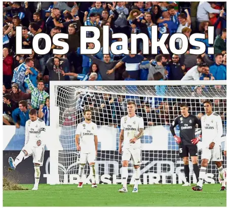  ??  ?? What a night: Real Madrid players reacting to Alaves’ goal during the La Liga match at the Mendizorro­tza Stadium on Saturday. — AFP