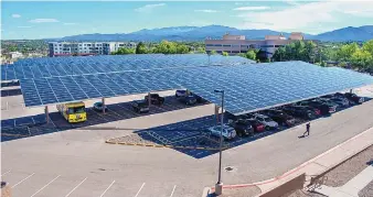  ?? EDDIE MOORE/JOURNAL ?? The state has installed a 1.6 megawatt solar carport on the parking lot at its South Capitol campus in Santa Fe.