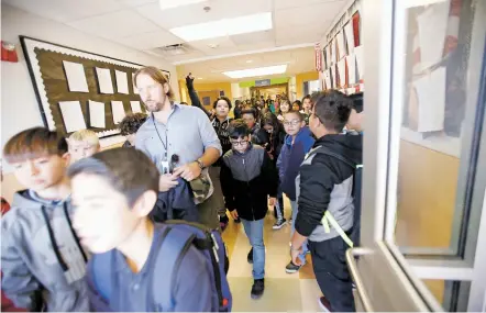  ?? LUIS SÁNCHEZ SATURNO/THE NEW MEXICAN ?? Students at Amy Biehl Community School walk out for recess Tuesday. The Santa Fe school board later that day capped enrollment at Amy Biehl, which at 543 students, is over capacity by 28 students.