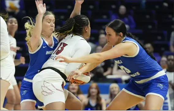  ?? GERALD HERBERT — THE ASSOCIATED PRESS ?? Middle Tennessee guard Savannah Wheeler and forward Courtney Whitson, right, trap Louisville guard Merissah Russell during the first half in Baton Rouge, La., Friday.