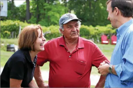  ?? PHOTOS BY JOHN FITTS — THE REGISTER CITIZEN ?? Maria and Manny Miranda share a laugh with U.S. Sen. Chris Murphy, who toured the couple’s vineyard in Goshen on Friday afternoon.