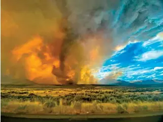  ?? KATELYNN & JORDAN HEWLETT VIA AP ?? A funnel appears in a thick plume of smoke from the Loyalton Fire in Lassen County, Calif., on Saturday.