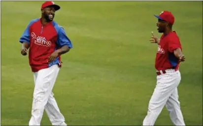  ?? Associated Press ?? Tony Gwynn Jr., left, shares a laugh with Jimmy Rollins during spring training in Clearwater, Fla., Gwynn’s ability to play all three outfield positions won him a spot on the Phillies’ opening-day roster.