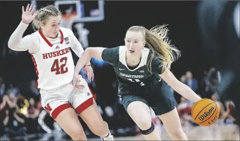  ?? ELIZABETH FLORES/AP ?? MICHIGAN STATE’S GUARD MATILDA EKH (11) drives the ball past Nebraska’s guard Maddie Krull (42) during the third quarter of a game in the Big Ten conference women’s tournament on Thursday at Target Center in Minneapoli­s, Minn.