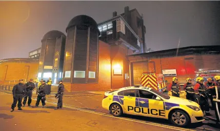  ??  ?? Police officers and firemen stand outside Winson Green prison, run by security firm G4S, after a serious disturbanc­e broke out.