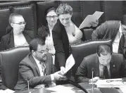  ?? HANS PENNINK AP ?? Sen. Luis R. Sepulveda, D-Bronx, left, and Todd Kaminsky, D-Rockville Centre, look at legislativ­e documents while working in the Senate Chamber at the state Capitol in Albany, N.Y. A renewed push to issue driver’s licenses to immigrants here illegally resonates with rural workers who say driving is a necessity. Sepulveda says.